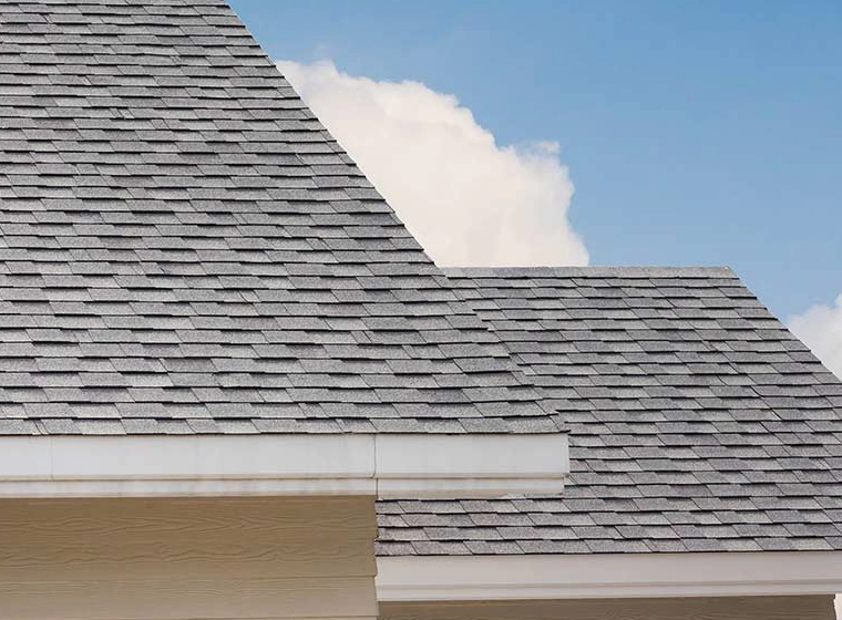 beige house with white sidings and a grey roofing